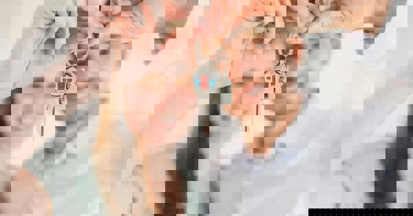 Blurred Image Of Couple Holding House Keys Rdn