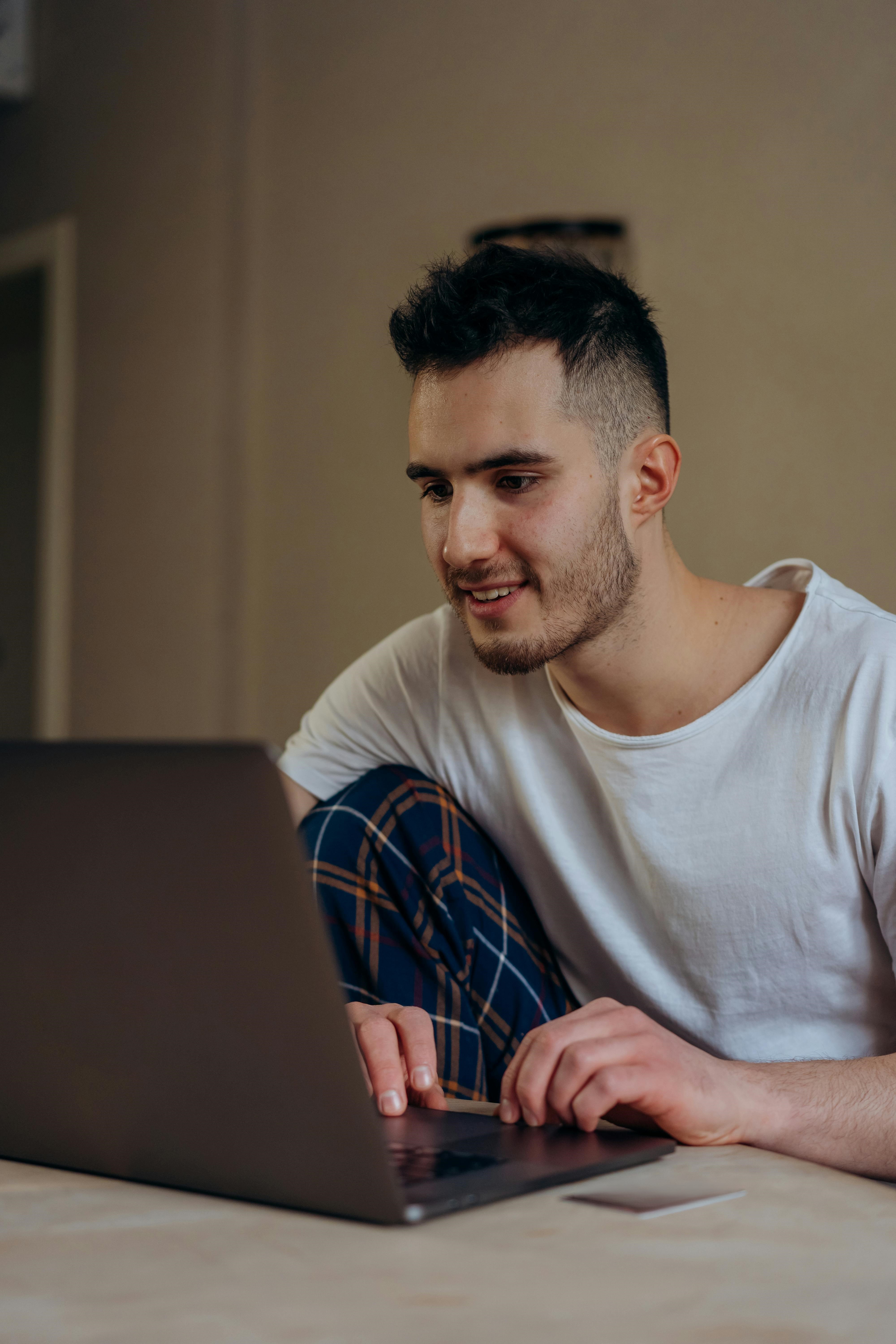 Man At Computer Pexels Mikhail Nilov 6969748