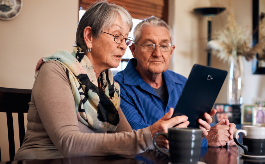 Older Couple Looking At Tablet Screen